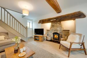 a living room with a fireplace and a couch at 6 Bed in Machynlleth oc-bow374 in Cemmaes