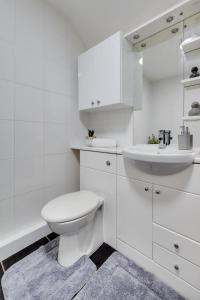 a white bathroom with a toilet and a sink at 6 Bed in Machynlleth oc-bow374 in Cemmaes +33 photos