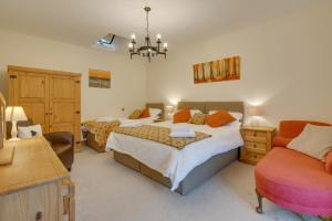 a bedroom with two beds and a chair at 6 Bed in Machynlleth oc-bow374 in Cemmaes