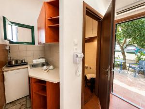a kitchen with a sink and a door to a yard at Hotel Hagiati in Chorefto +134 photos