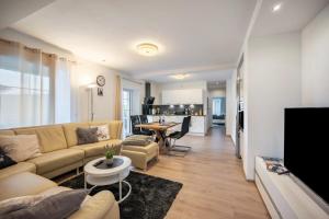 a living room with a couch and a table at Haus Burgblick in Badenweiler