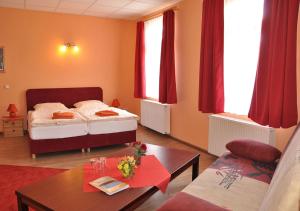 a living room with two beds and a table at Pension Haus Saarland in Oberhof