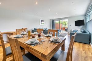 a dining room and living room with a wooden table at 4 Bed in Winnards Perch oc-t29558 in Saint Columb Major