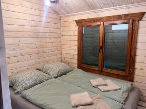 a bedroom with a bed in a wooden wall at Relax nad Narwią u Oli Pawła in Chmielewo