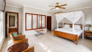 a bedroom with a bed with a canopy at Giney's View 8 Unit in Vilanculos +19 photos