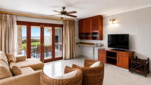 a living room with a couch and a flat screen tv at Giney's View 8 Unit in Vilanculos