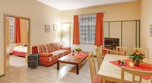 a living room with a couch and a table at Pension Haus Saarland in Oberhof