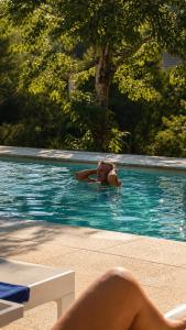 a person swimming in a swimming pool at Villa Boutique 1880-Romantic Historic Boutique Hotel with Outdoor Jacuzzi in San Salvador