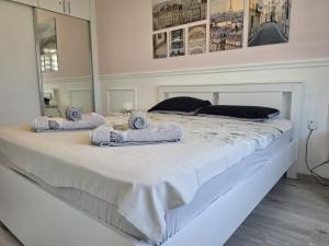a bedroom with a large white bed with towels on it at Caesar Resort & Spa Luxury Apartments in Iskele +44 photos