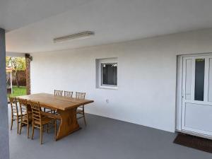 a dining room with a wooden table and chairs at Danube Exclusiv in Calafat