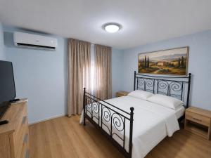 a bedroom with a black bed and a television at Danube Exclusiv in Calafat