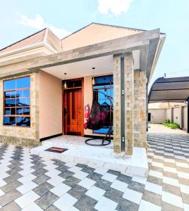 a house with a front door and a tile floor at R&E Apartments in Dodoma