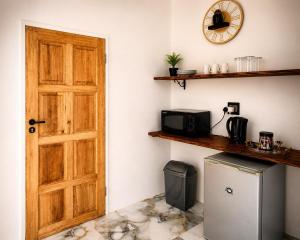 a door in a room with a refrigerator and a microwave at 1010 On The Edge in Mokhotlong