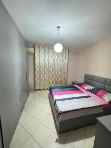 a bedroom with a bed in a room at Kodra Apartament in Golem