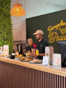 a couple of people standing at a counter with food at Suite de Lujo Piscina Hidromasaje in Quito +53 photos