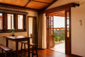 a room with a table and a door to a balcony at Sola Hoi An in Thanh Ðông (1)