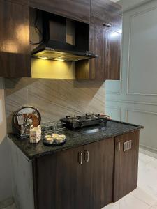 a kitchen with a stove and a counter top at Couple friendly spacious 1BHK in Indore