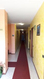 a hallway with a red carpet in a building at Hotel Armida in Castenedolo