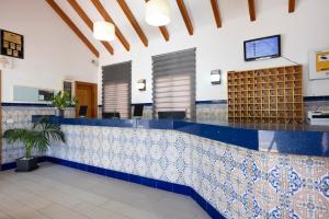 a lobby with a blue and white tile counter at Ona Los Claveles in Los Cristianos +29 photos