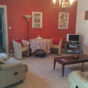 a living room with a table and chairs at Mirailh in Amou