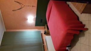 a bedroom with a bed with a red blanket at Albergo Armida in Castenedolo