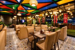 a restaurant with tables and chairs and a bar at The Arcadia Coimbatore Airport in Coimbatore