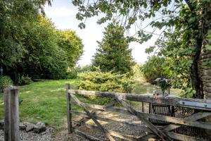 an old wooden gate in a garden at Finest Retreats - The Little Barn in Great Somerford +5 photos