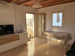 a kitchen and dining room with a table and chairs at Mas De La Salut in Sant Jaume Sas Oliveras