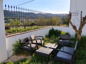 a group of chairs and tables with a view at Mas De La Salut in Sant Jaume Sas Oliveras