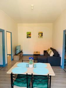a living room with a table and a couch at Appart cosy avec billard, à Bort in Bort-les-Orgues