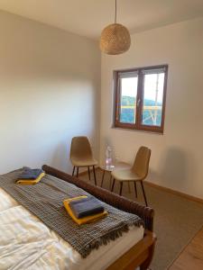 a bedroom with a bed and a table and chairs at Villa Kasimir in Videm pri Ptuju