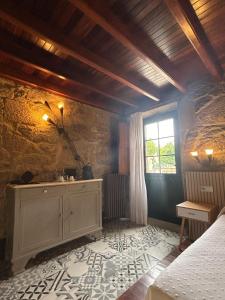 a bedroom with a bed and a window at Casa de Costoia in Santiago de Compostela