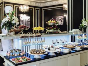 a buffet with many different types of desserts on display at Mövenpick Hotel Casablanca in Casablanca