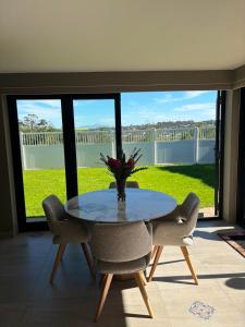 a dining room with a table and chairs and a large window at Mount Glow Self-Catering in Swellendam