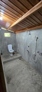 a bathroom with a toilet and a shower at Eco Palms in Pottuvil +21 photos