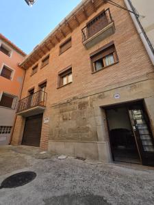 a brick building with its doors open on a street at Casa Ioar in Los Arcos