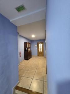 a hallway with a room with blue walls and a door at Casa Ioar in Los Arcos