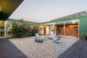 a patio of a house with white chairs at Stars View by Portugal Active in Fafe