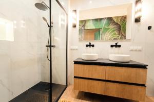 a bathroom with two sinks and a shower at Apartament Kutno - Sami Swoi in Kutno
