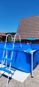 a table and two chairs next to a swimming pool at Planinska kuca-Jovanovic! in Kremna