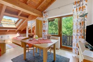 a room with a table and a bed and a desk at Ferienwohnungen Im Försterhaus in Lonsee