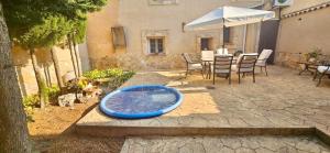 a blue tub sitting on a patio with a table and an umbrella at Casa Turística Los Girasoles 