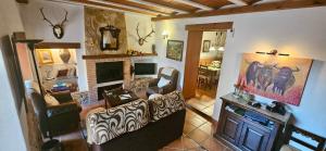 a living room with a couch and a fireplace at Casa Turística Los Girasoles 