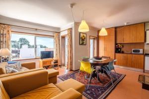 a living room with a couch and a table at Ocean view Cabedelo Beach Duplex in Viana do Castelo