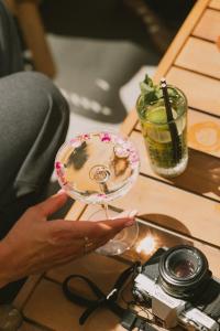 a person holding a plate on a table with a camera at Le Riviera - Hôtel Restaurant & Spa - Ex Golden Tulip Aix les bains in Aix-les-Bains +89 photos