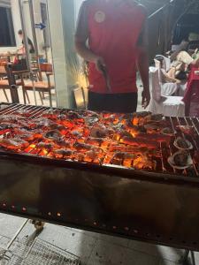 a man standing in front of a large buffet of food at Trang An Heritage Hotel in Nguyên Ngoại