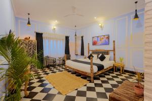a bedroom with a bed and a checkered floor at Wanderlust A Boutique Homestay in Udaipur