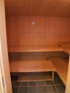 a sauna with wooden shelves and a clock on the wall at Hotel Alhambra in La Orotava