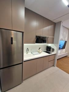 a kitchen with a sink and a refrigerator at Sea Breeze Vibe in Nardaran