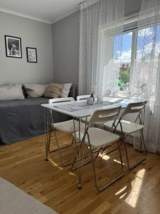 a dining table and chairs in a living room at Lindens Bed&Breakfast in Mellerud